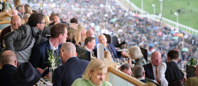 punters enjoying food while watching race in cheltenham racecourse hospitality