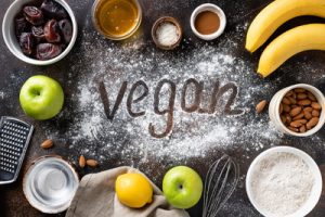 vegan written in flour with fruits and nuts