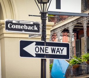 street sign with comeback and one way written