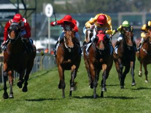 jockey using the whip in a race